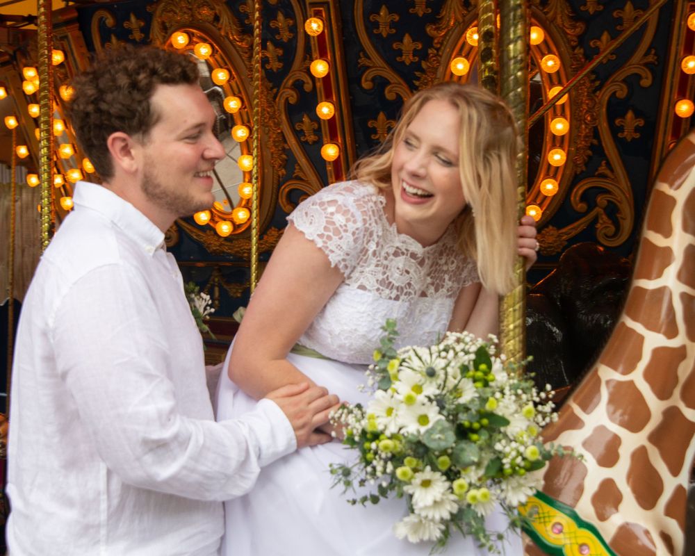 A joyful wedding moment captured with a gorgeous bouquet of white flowers against decorative lights and giraffe print backdrop.