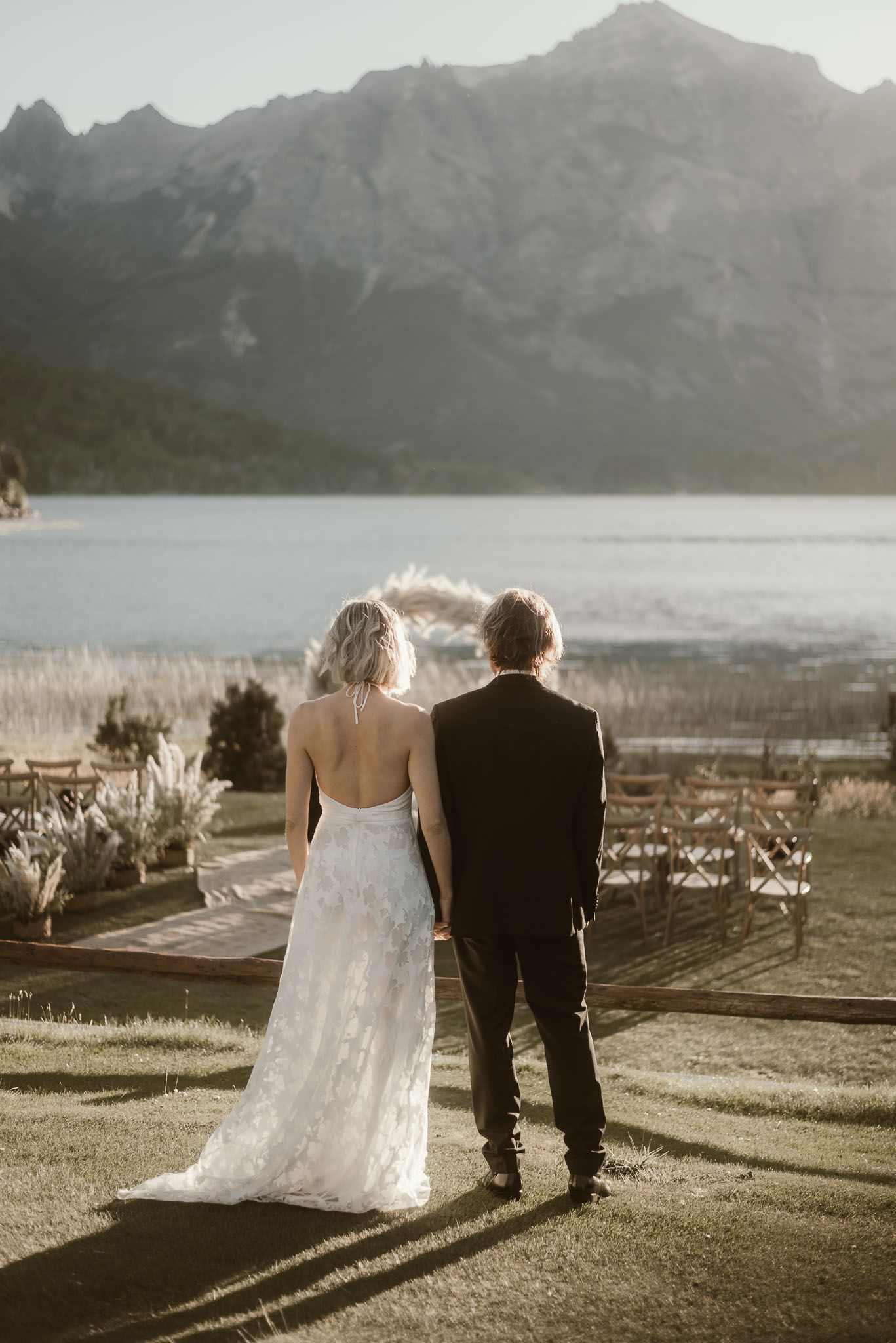 Classic wedding portraits at the historic resort gardens. Newlyweds posing with the iconic wooden architecture and Tronador Hill as a majest
