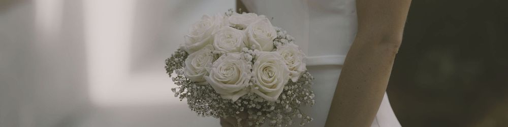 Elegant wedding decor with white roses and floral arrangements on display.