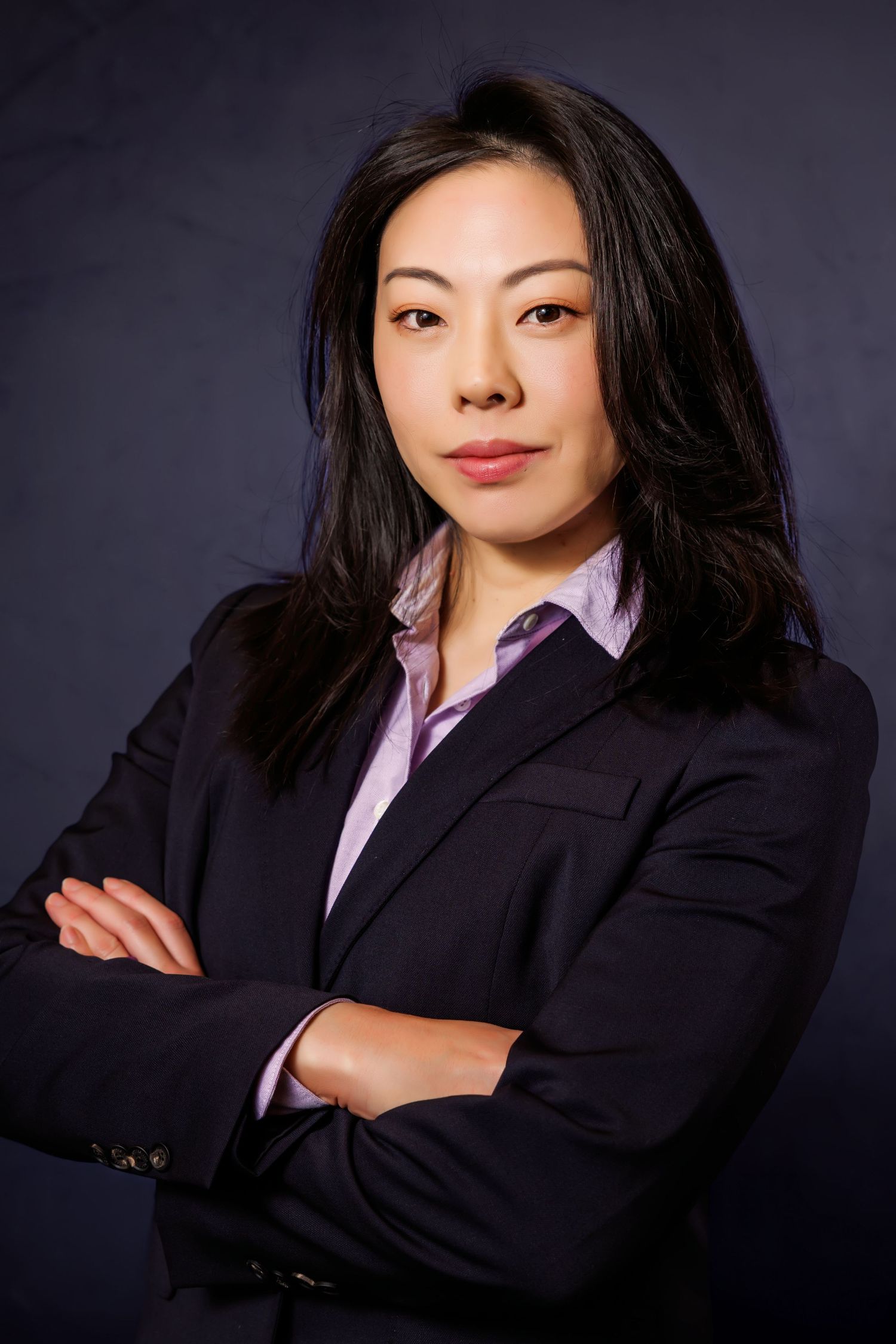 Professional business portrait series showing woman in black blazer and purple shirt against dark background.