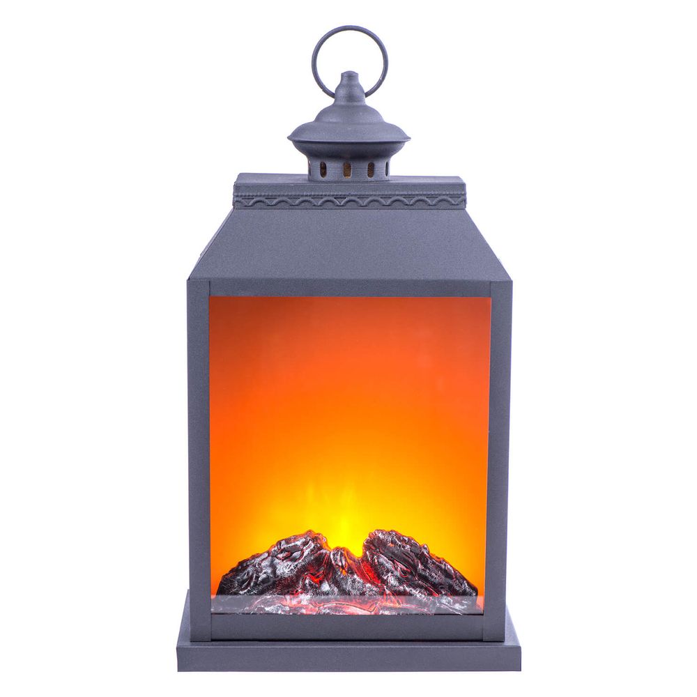 Decorative black lantern with LED flame effect and mountain scenery displaying warm orange glow.