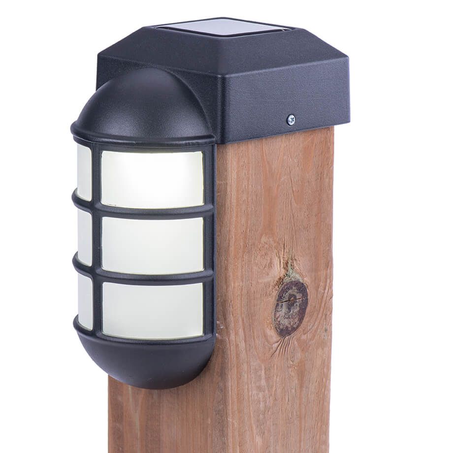 Black outdoor wall-mounted light with frosted glass panels shown mounted on wooden posts.