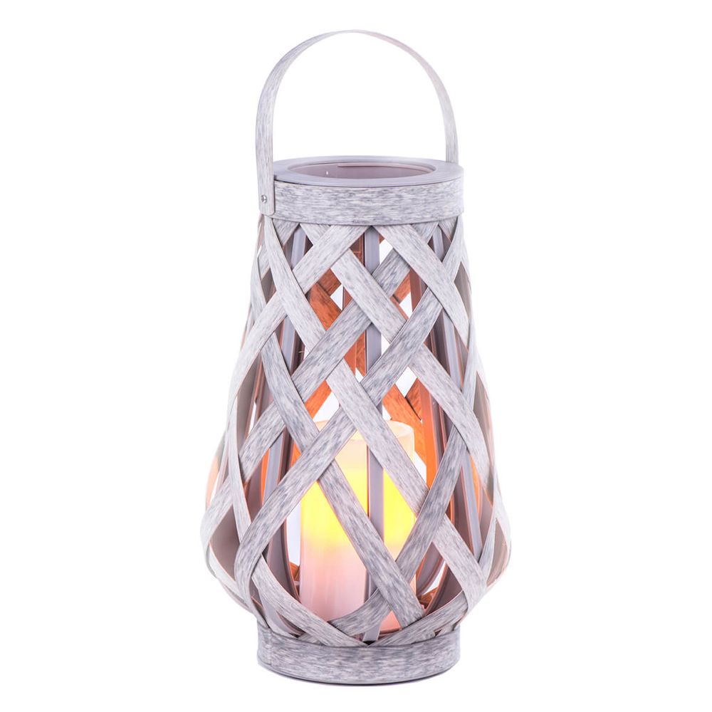 White decorative lantern with LED candle creating warm ambient glow through lattice pattern.