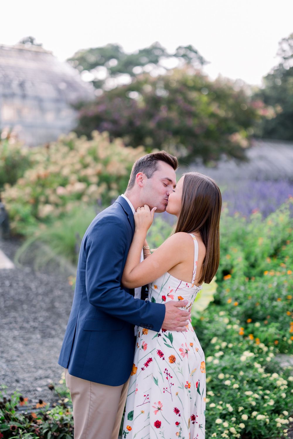 Romantic moment captured in blooming garden with flowers and greenery.