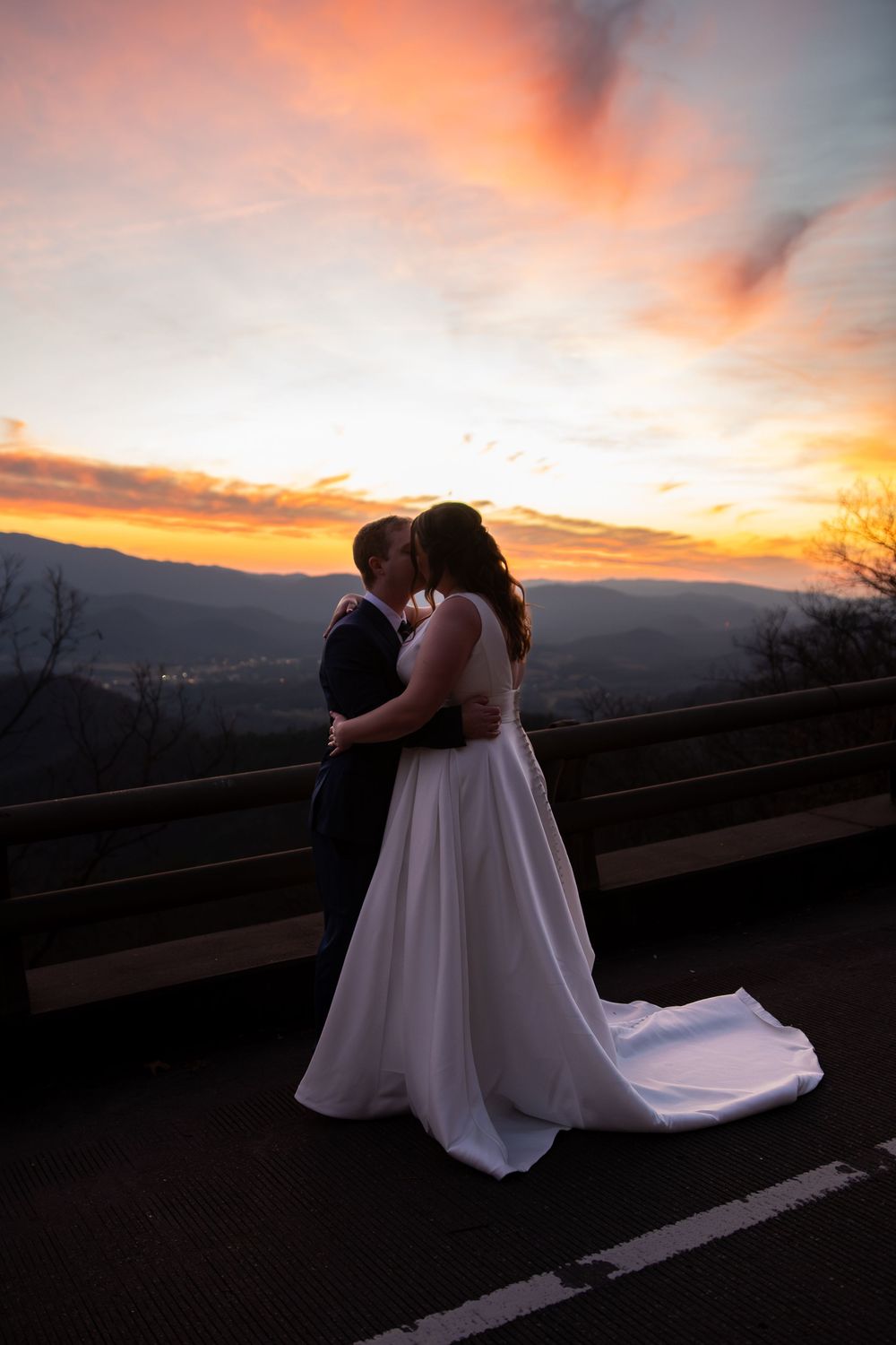 Romantic silhouettes against a dramatic orange mountain sunset.