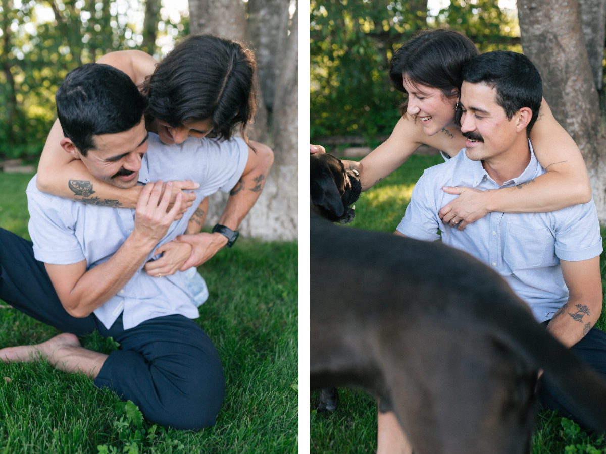 man and woman wrestle playfully in the grass
