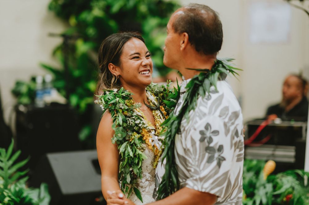 Wedding guests enjoying a celebration with tropical greenery decorations.