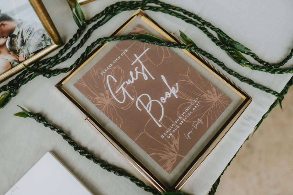 Wooden framed signs with handwritten text displayed at a wedding event.