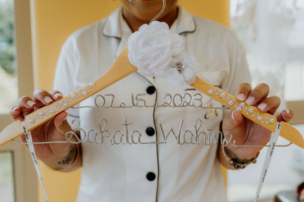 Wedding dress hanger with date inscription displayed.