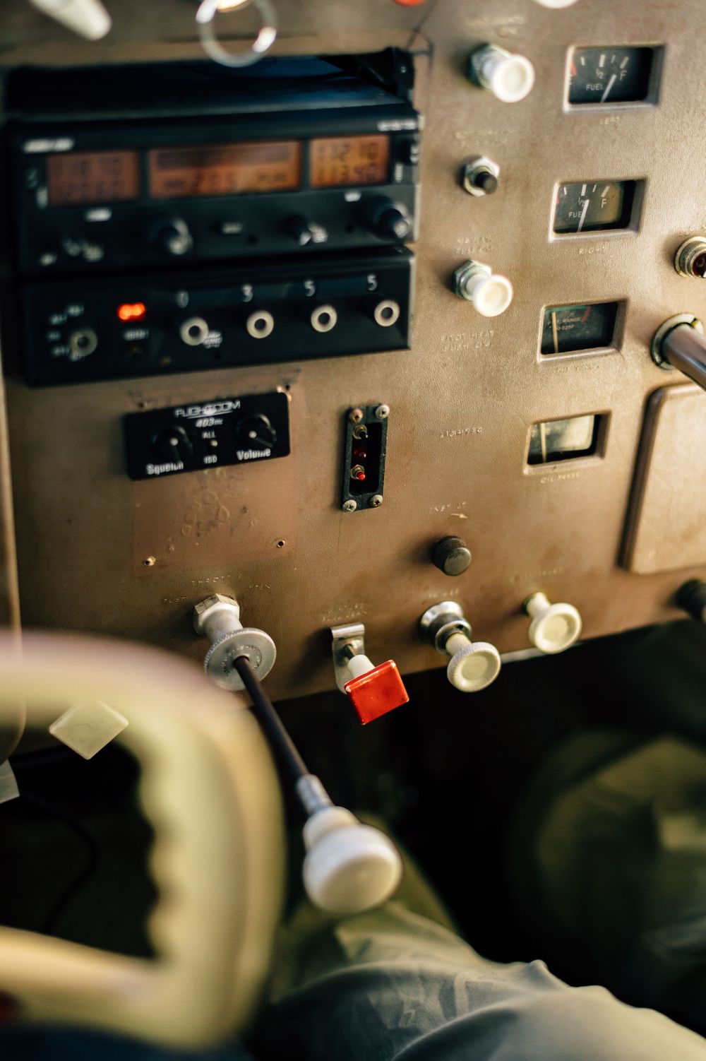 Detailed view of vintage aircraft control panel with switches and radio equipment.