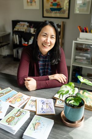 Woman posing for a photo with her stationary cards.