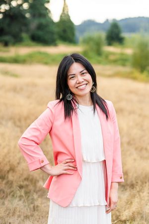 Woman smiling for a photo in a field in Woodinville.