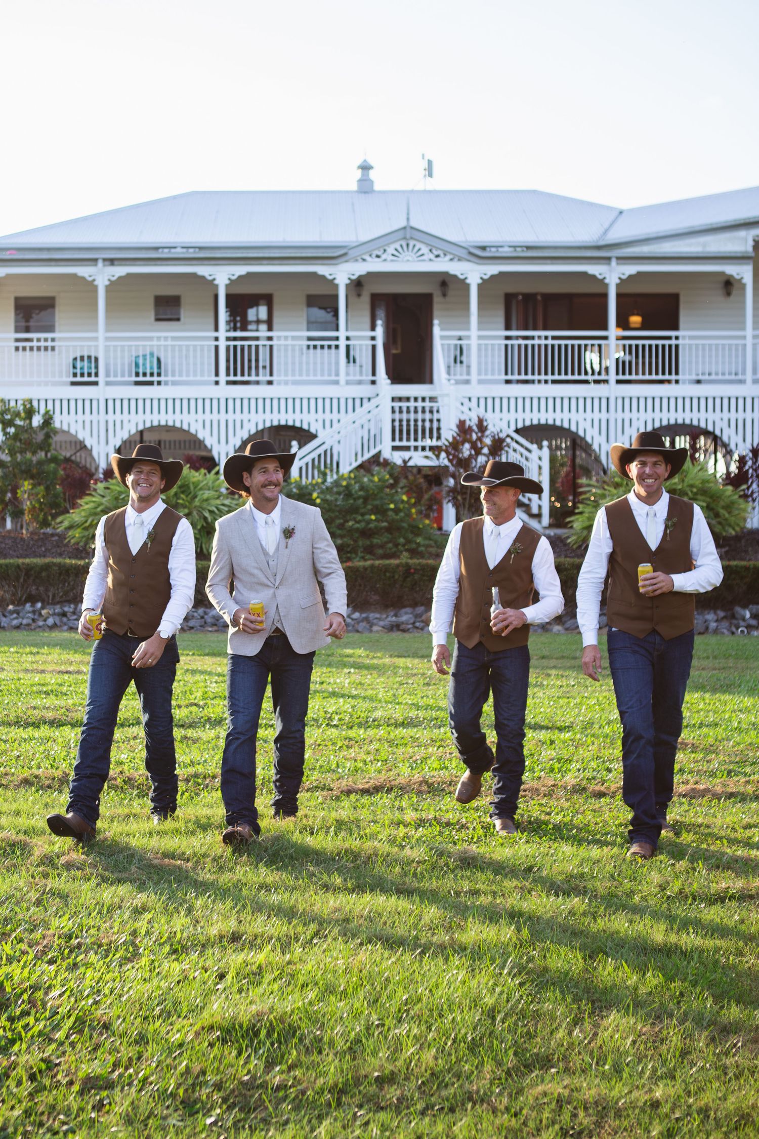 Groomsmen walking in front of Queenslander home at country Port Douglas Wedding