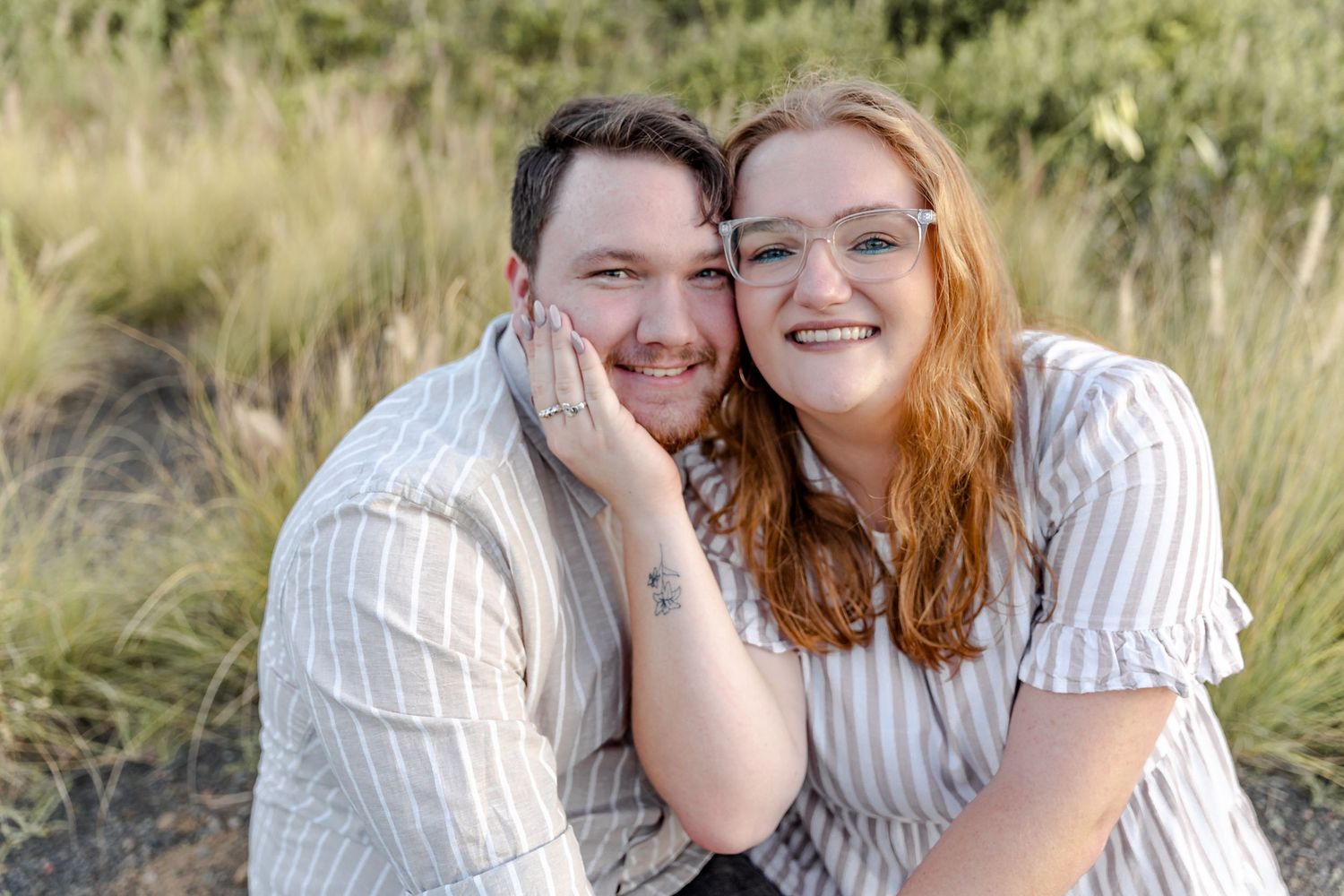 Engaged couple at Bombo Headlands with cliffs and ocean at sunset