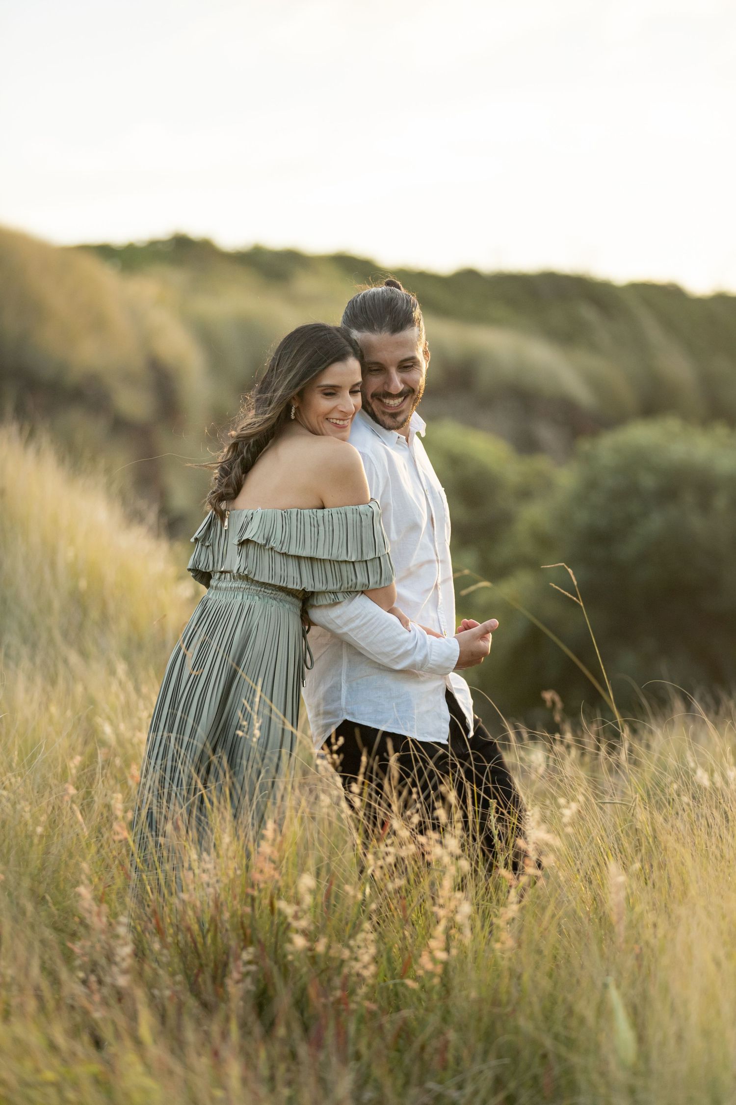 Engaged couple at Bombo Headlands with cliffs and ocean at sunset