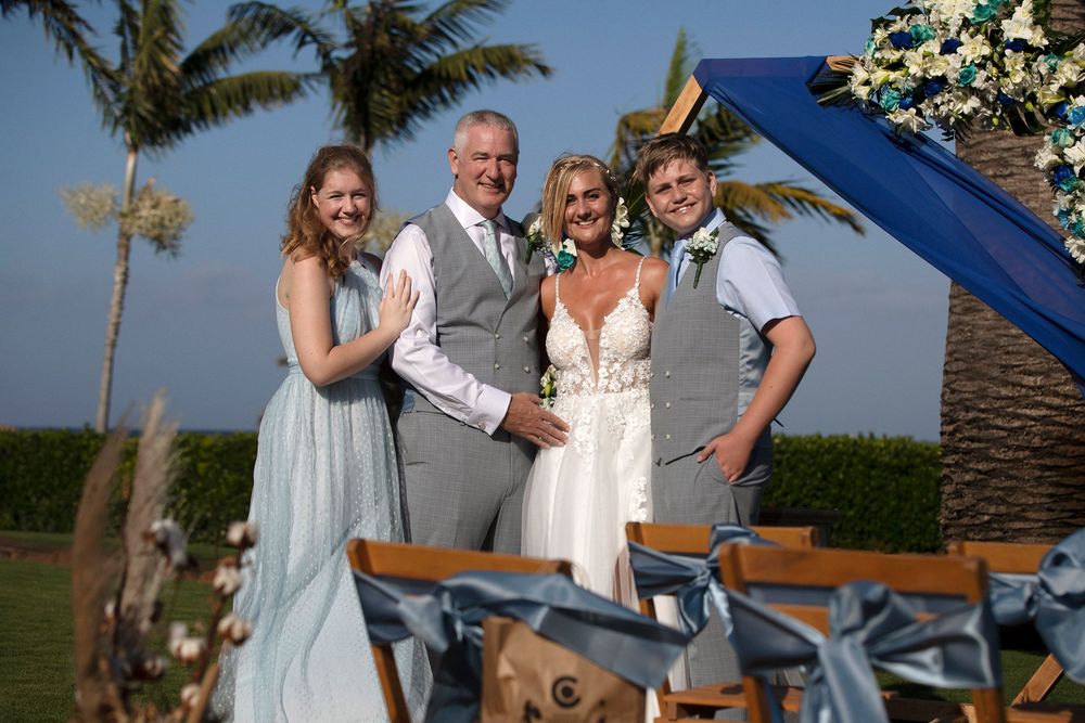 Family group posing under a wedding arch at the Sheraton Fuerteventura - Professional elopement photography