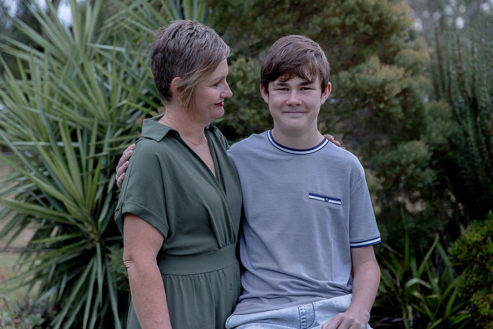 mother looking lovingly at her son during a professional mother's day photo shoot.