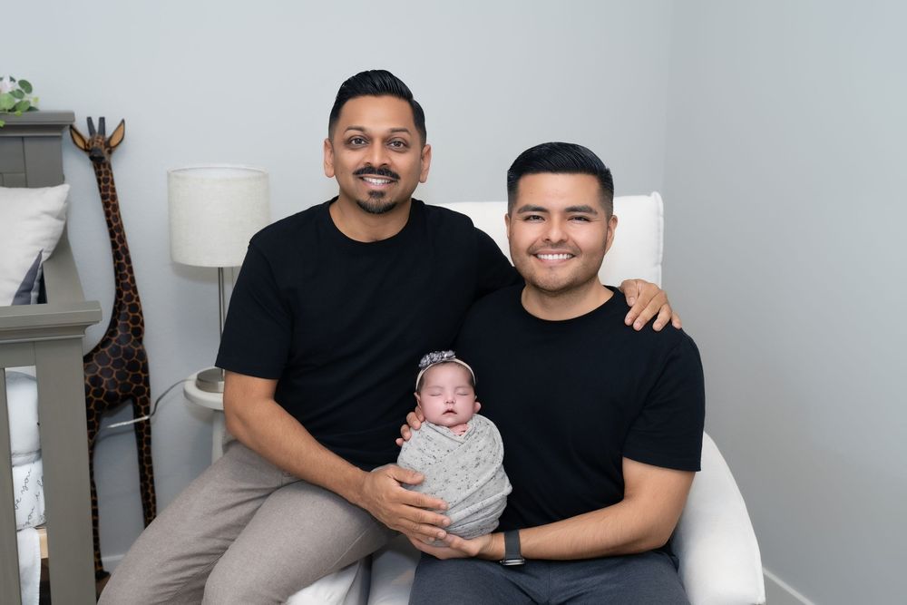 A collection of four family photos showing parents and baby in matching black shirts against a light background.