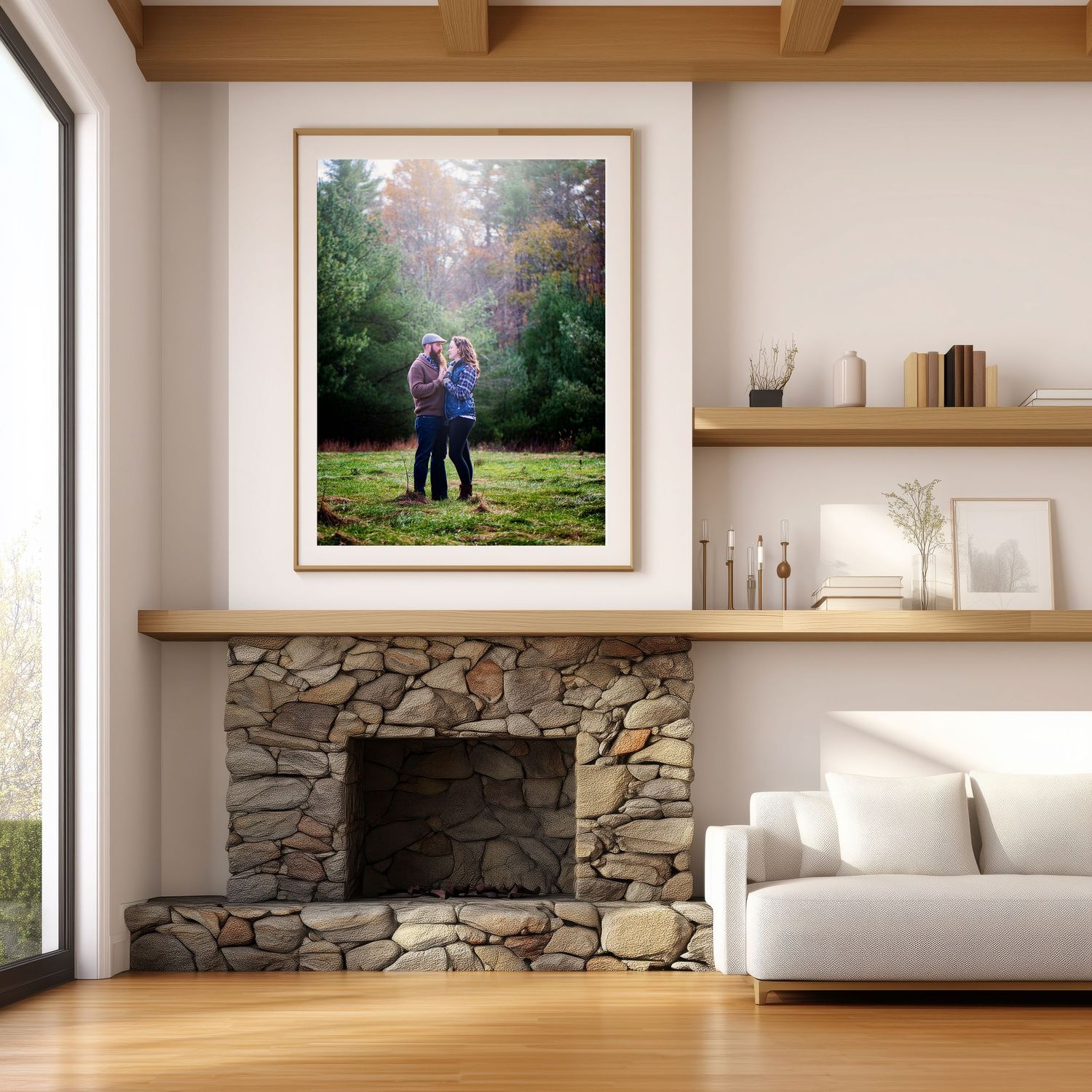 Modern living room interior with wooden shelves, stone fireplace, and framed landscape artwork on display.