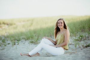 A series of romantic beach portraits showing a person in white clothing posing on sandy dunes at sunset.