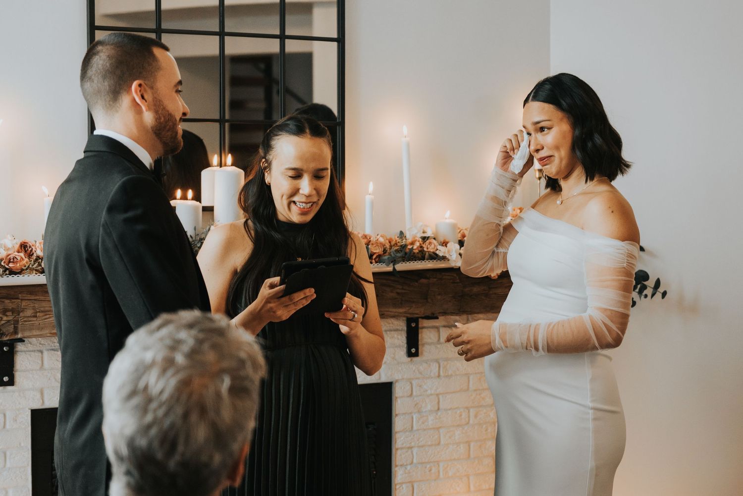 A wedding couple shares intimate moments during their reception celebration in an elegant indoor venue.