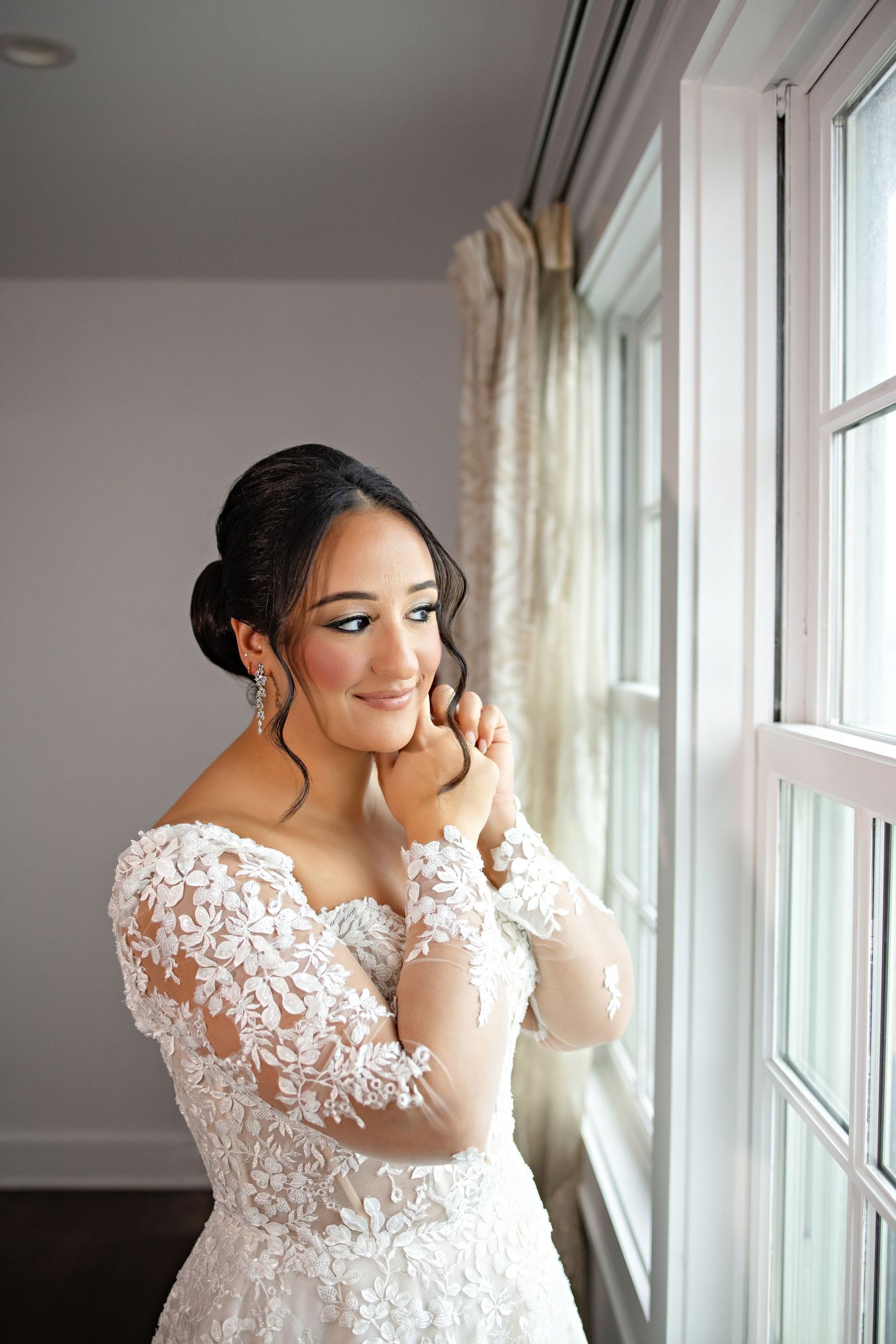 A romantic proposal scene set between rows of grapevines in a scenic vineyard with white flowers and a blanket.