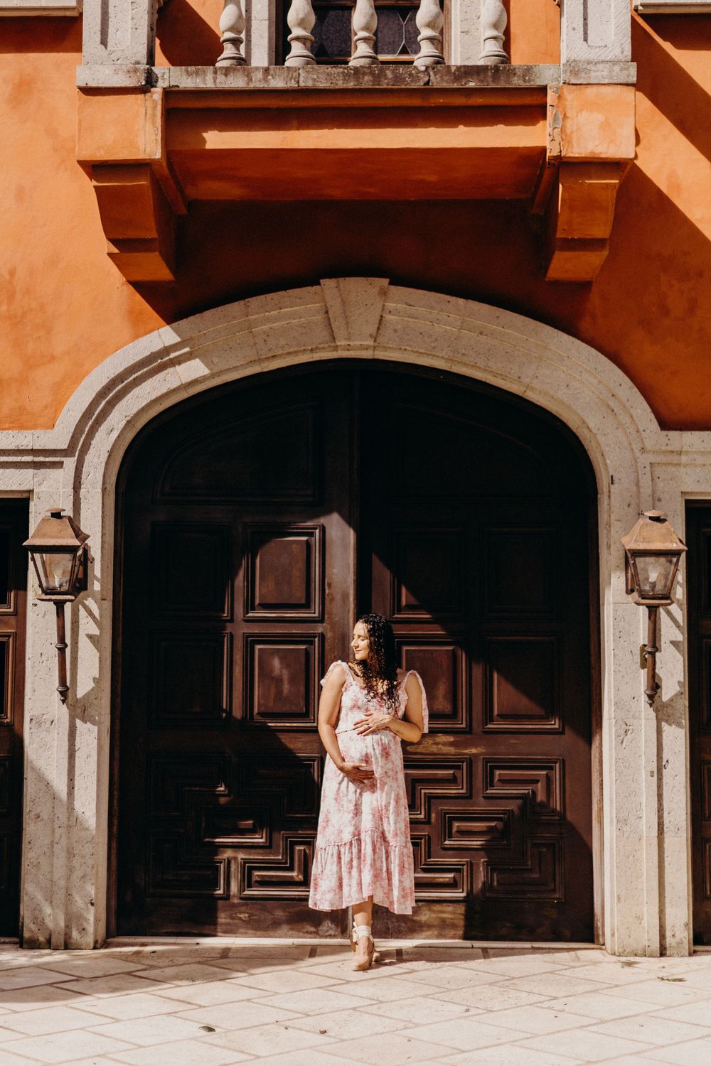 Series of architectural shots showing arched doorways and columns against terracotta colored building.