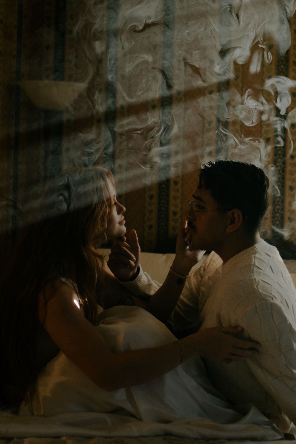Romantic couple sequence with dramatic shadows and intimate poses against textured wall.