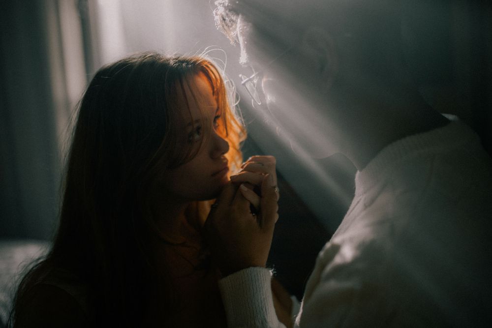 Atmospheric photograph with rays of light streaming through darkness.