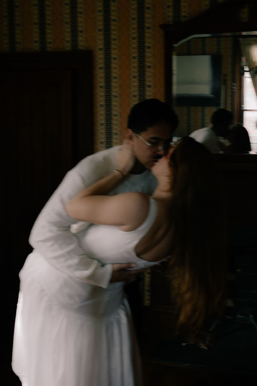 A series of romantic moments captured in dim lighting with soft focus.
