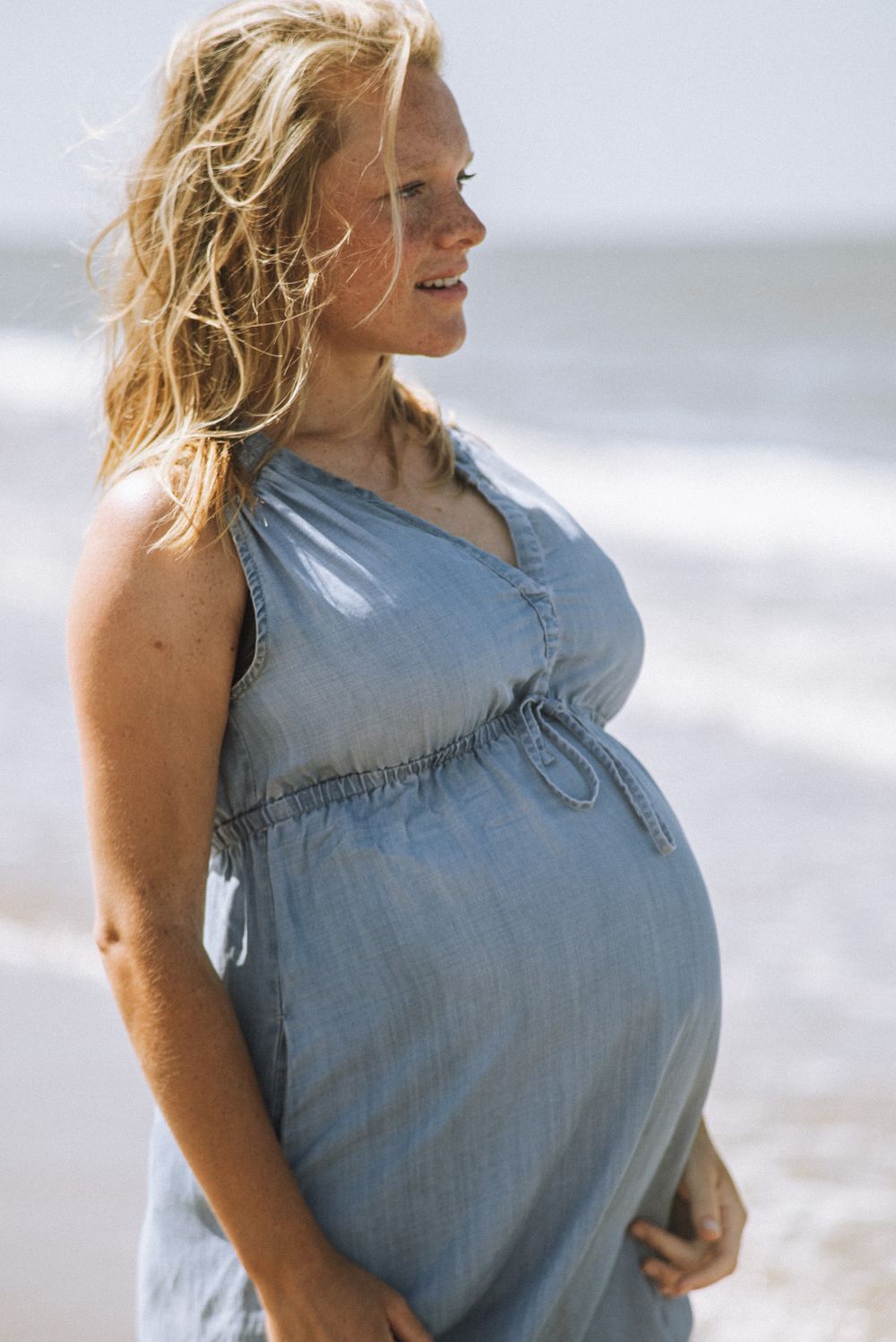 Casual beachside portrait in chambray dress with natural lighting.