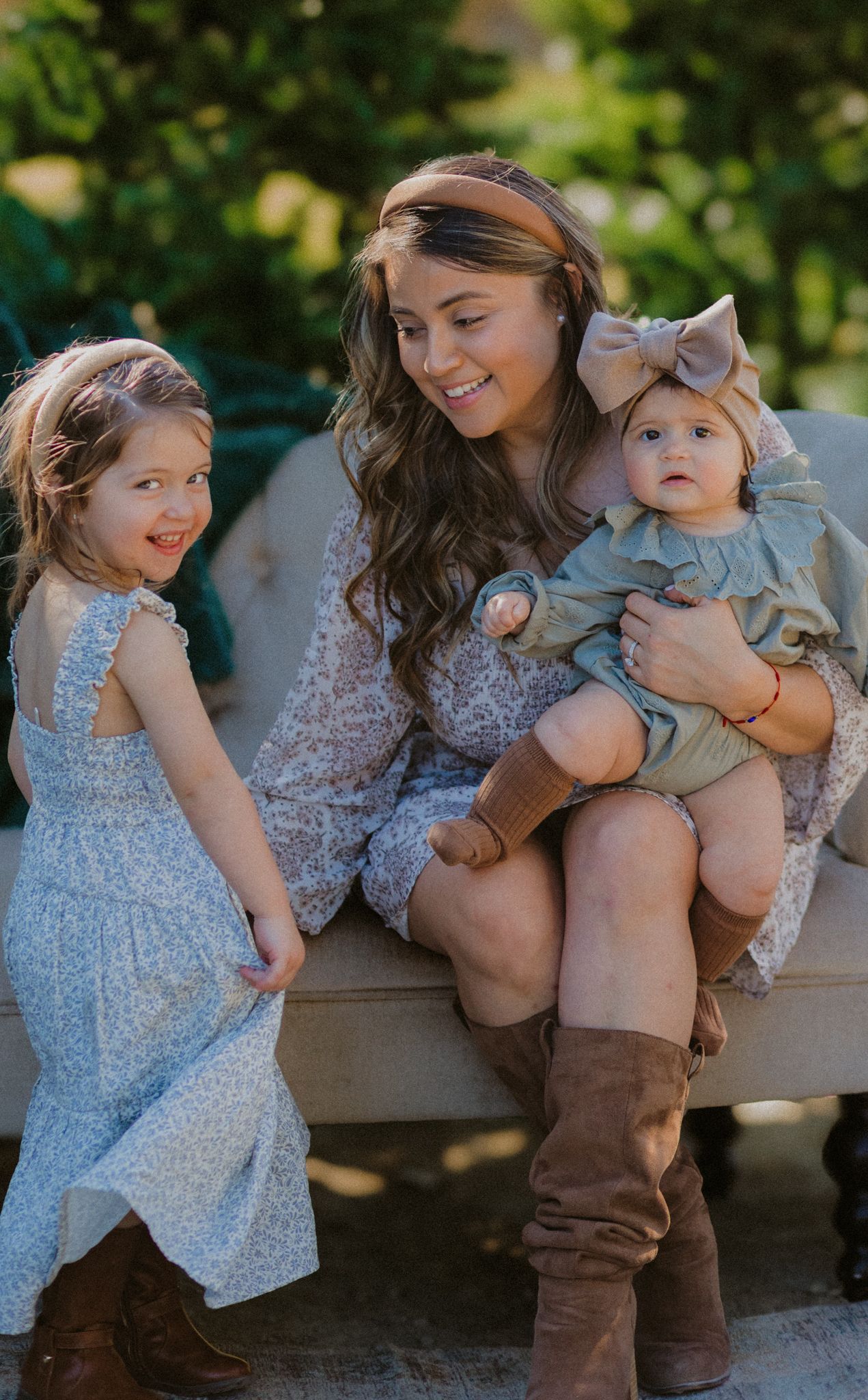 Family enjoying a sunny day together while sitting outdoors in coordinated outfits.