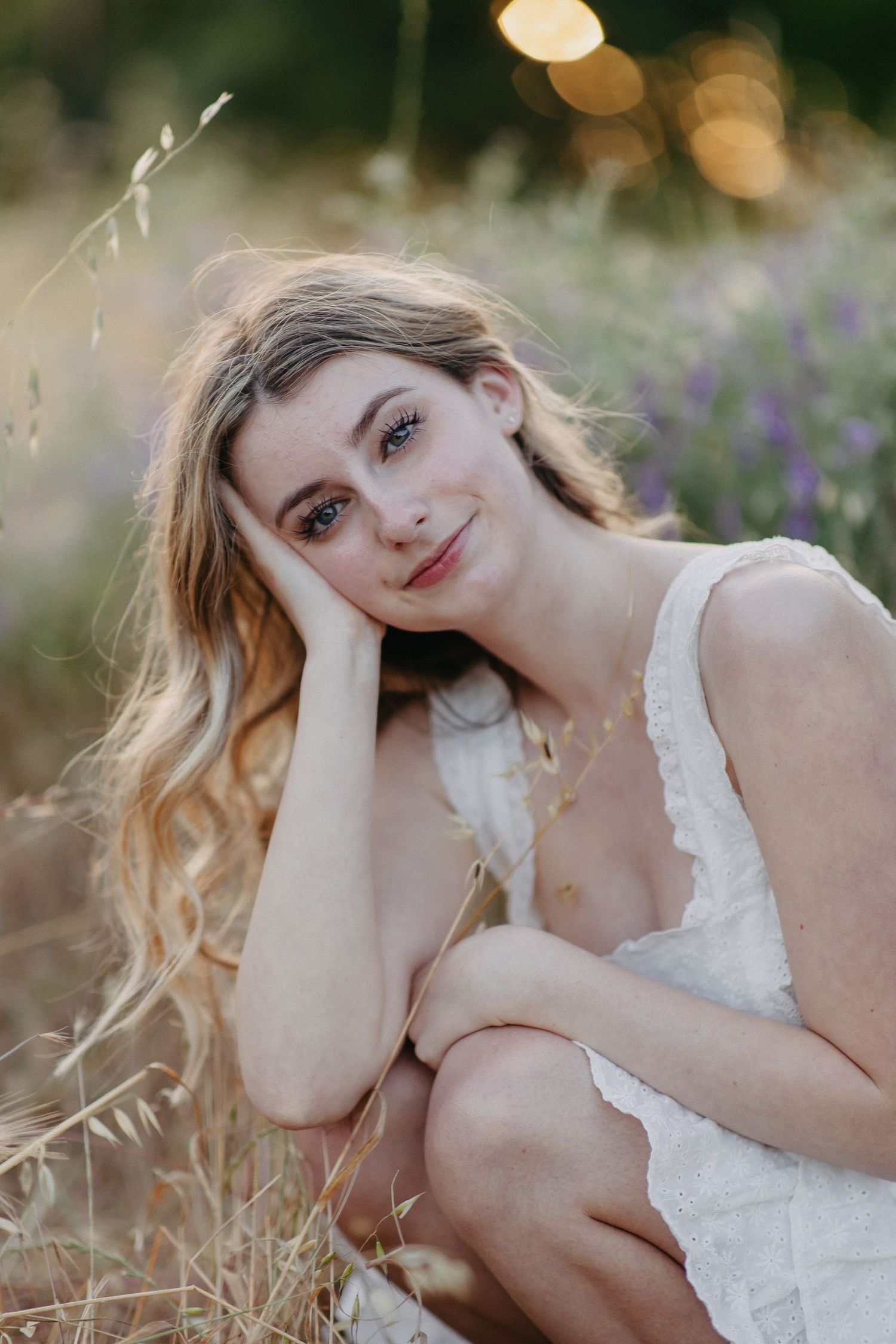 A dreamy summer portrait in a wildflower field with soft bokeh lighting at golden hour.