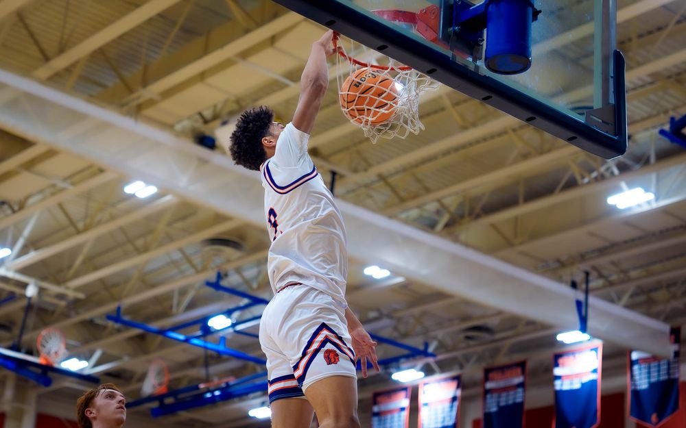 Cam Sweeney dunks during the playoff game, banners and fans in background by SportsFox Photography, Hershey PA.