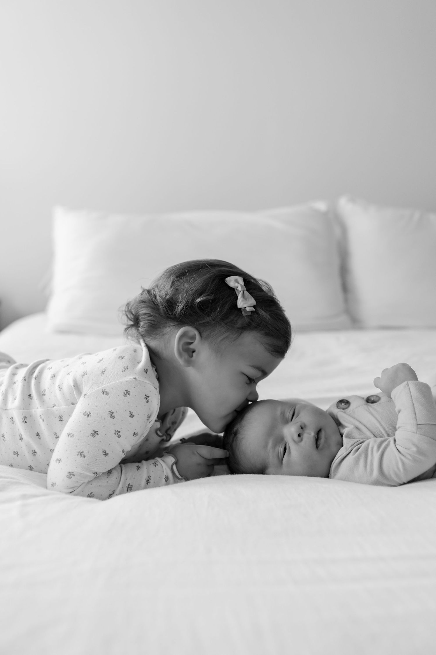 A sequence of six photos showing a baby rolling over on a soft blue blanket.