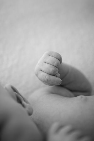 Artistic black and white photograph of small infant toes creating soft shadows.