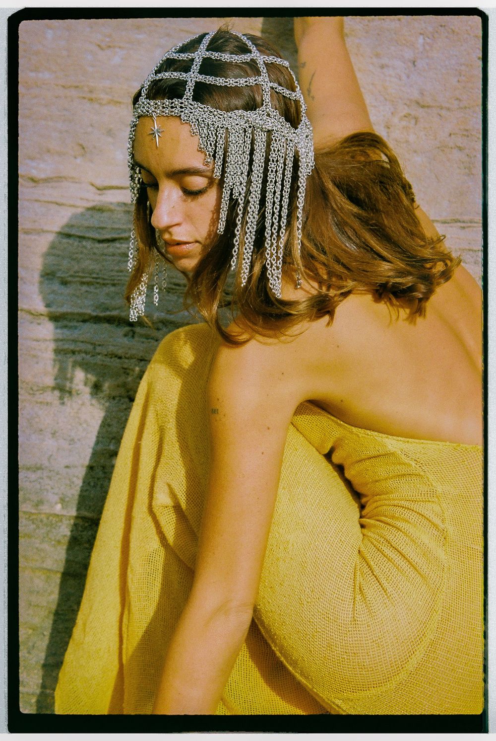 Artistic portrait series in warm golden tones featuring decorative metallic headpiece against textured wall background.