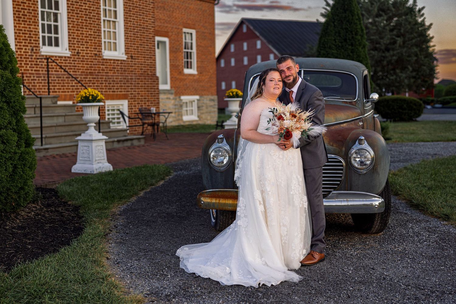 frederick maryland wedding photographer Wedding photos taken against classic car and brick church backdrop at dusk.