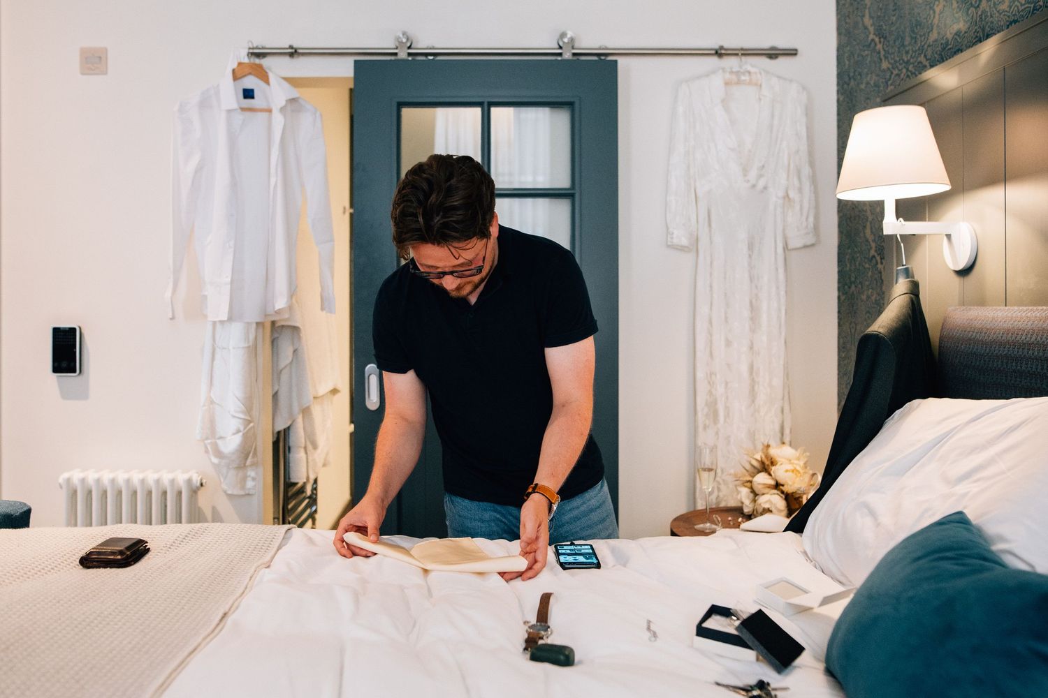 A series of photos showing a person making a bed with white linens and pillows in a hotel room.