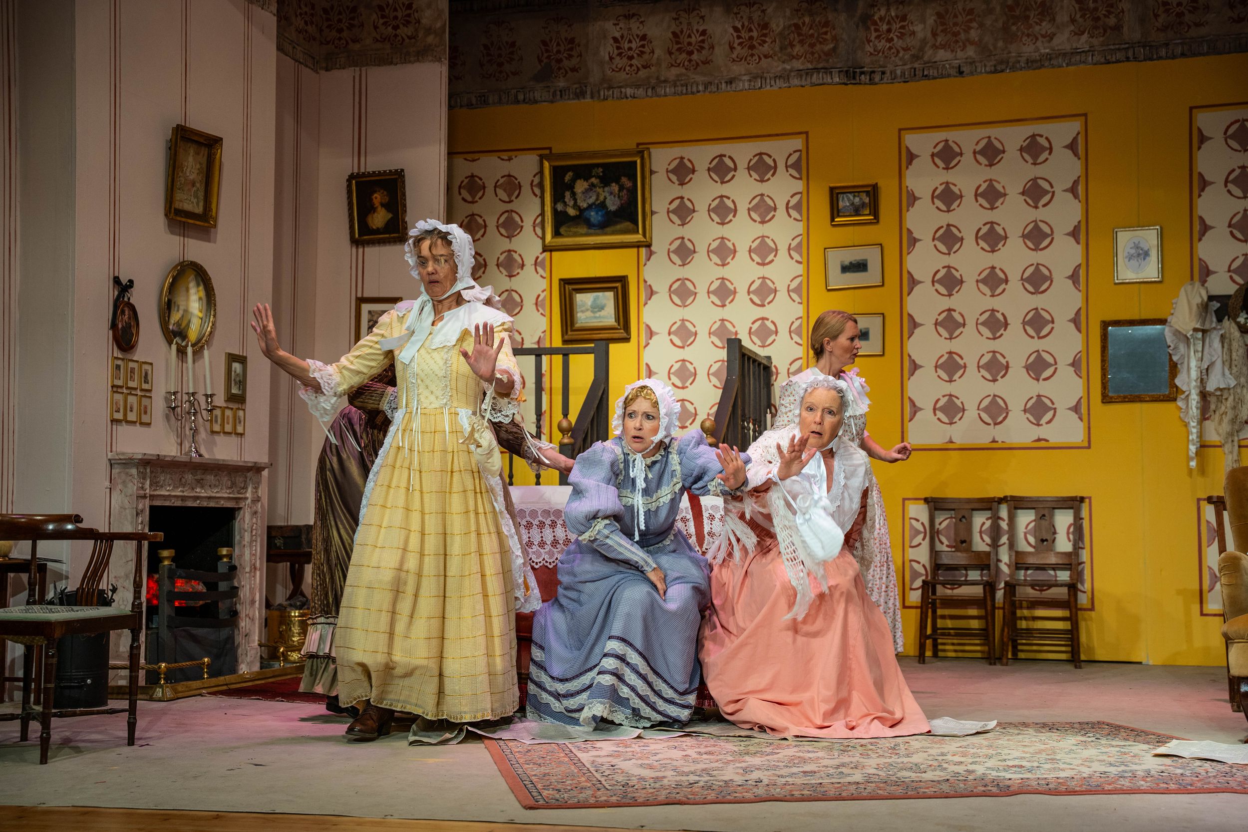 Brighton theatre photography. actresses on stage in victorian dresses some sitting down three standing up in a theatre show