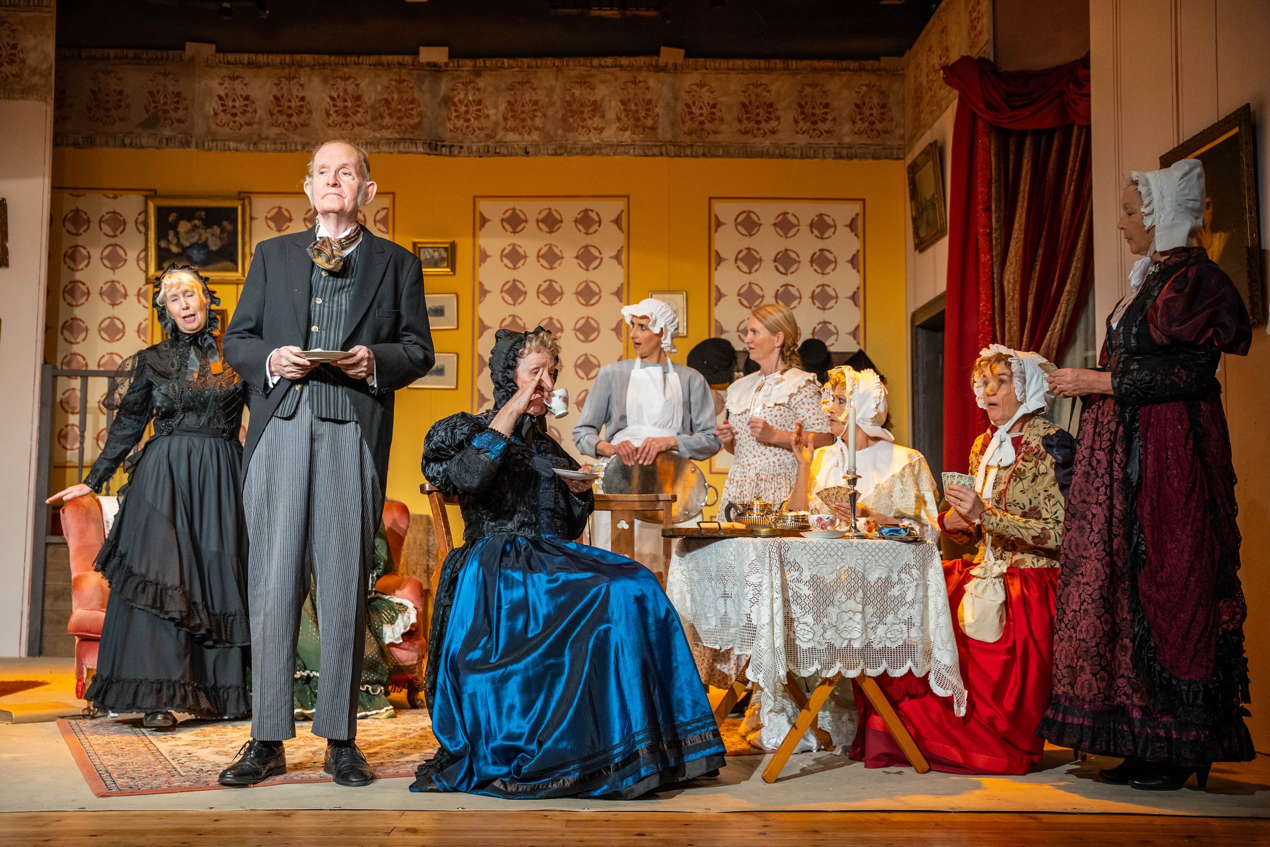 Brighton theatre photography. actresses on stage in victorian dresses some sitting down three standing up in a theatre show