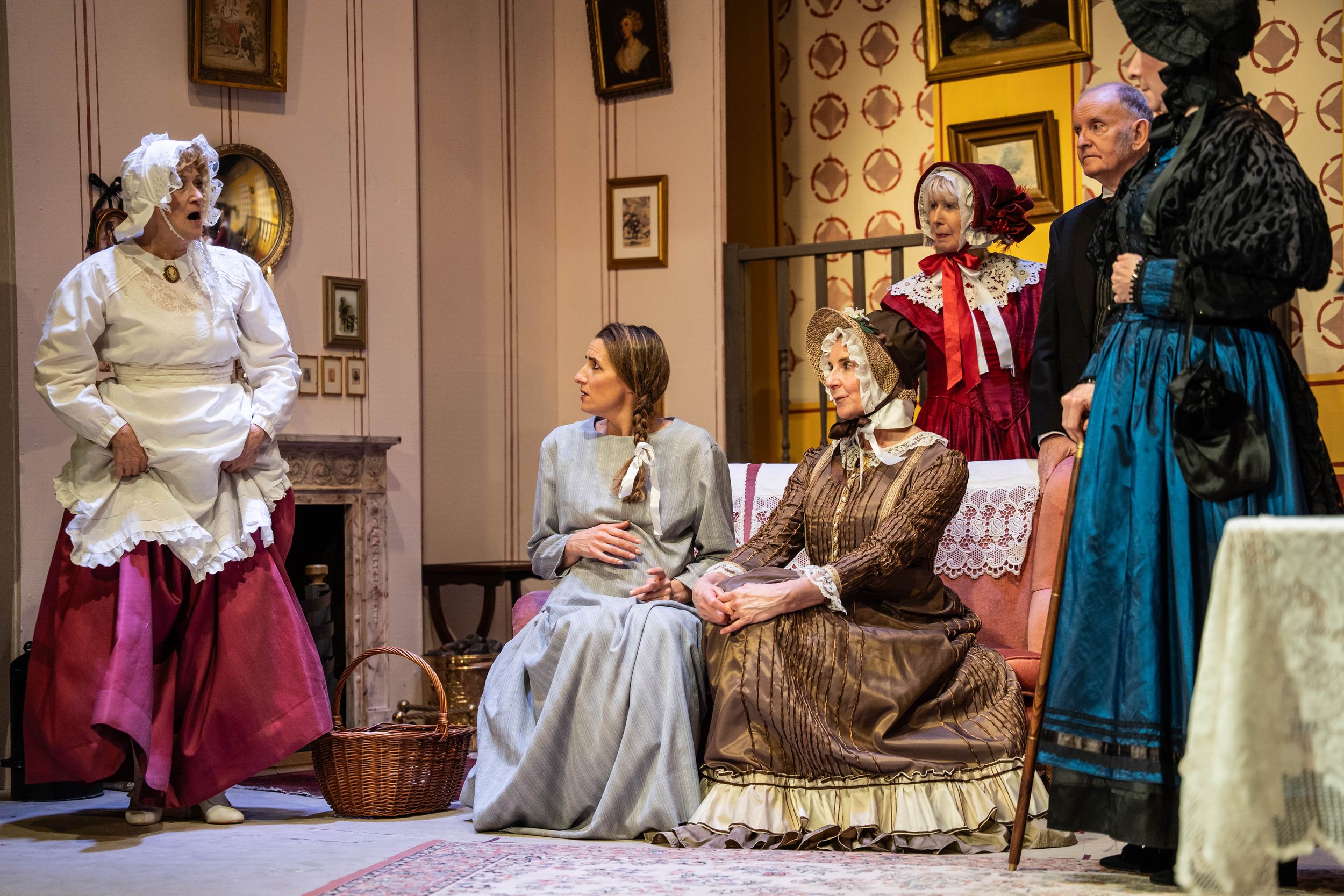 Brighton theatre photography. actresses on stage in victorian dresses some sitting down three standing up in a theatre show