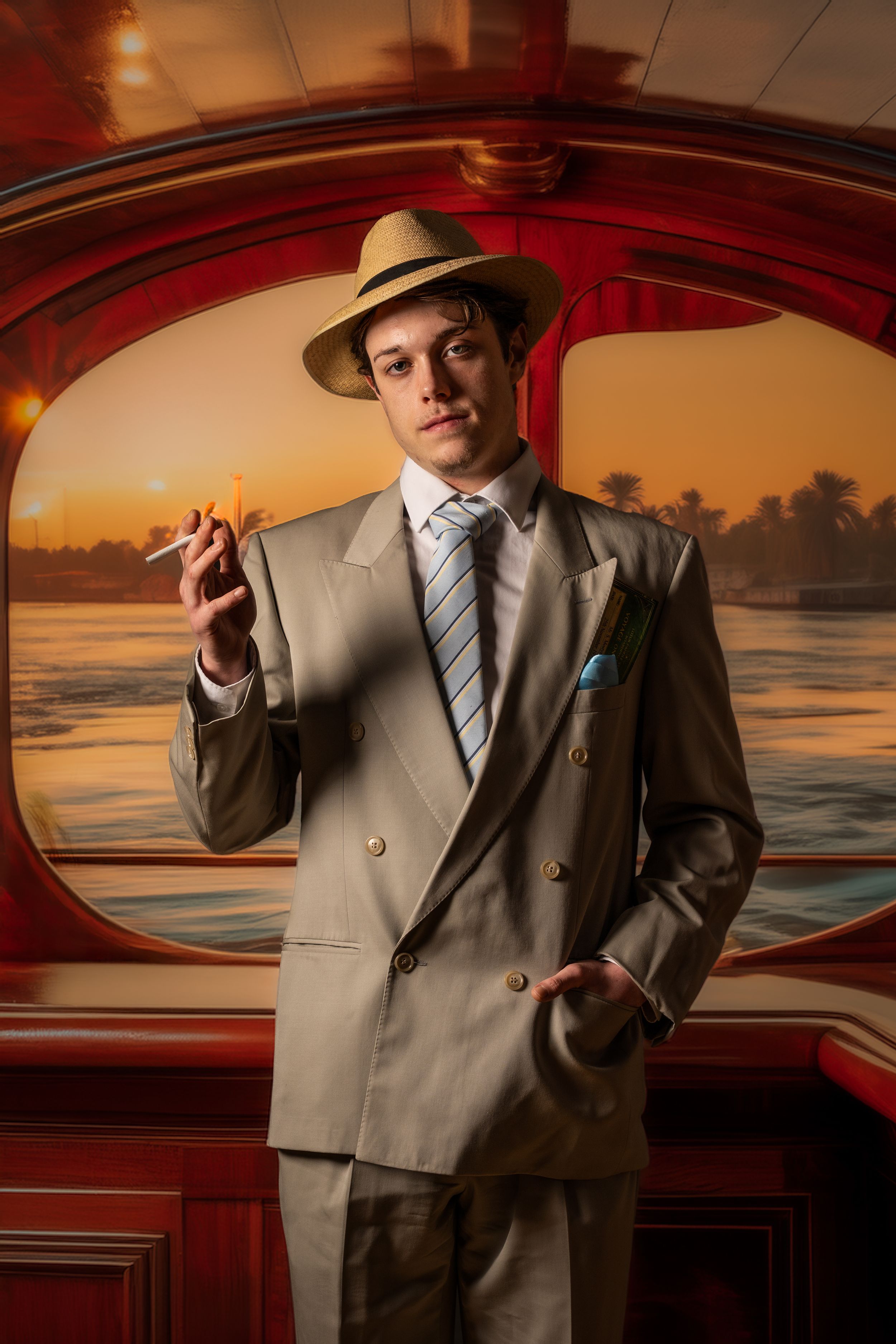 theatre photography promo shot Brighton of a man wearing 30,s costume stands on a paddle steamer smoking a cigarette