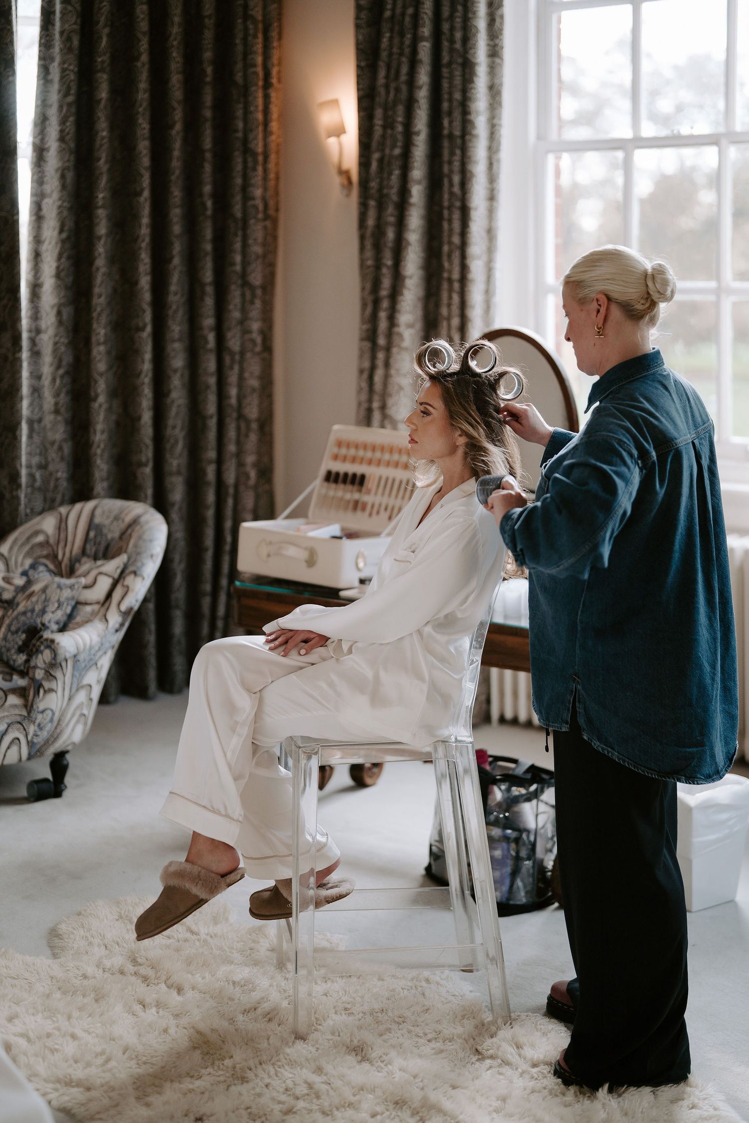 hair stylist taking brides hair out of collars at Iscoyd park