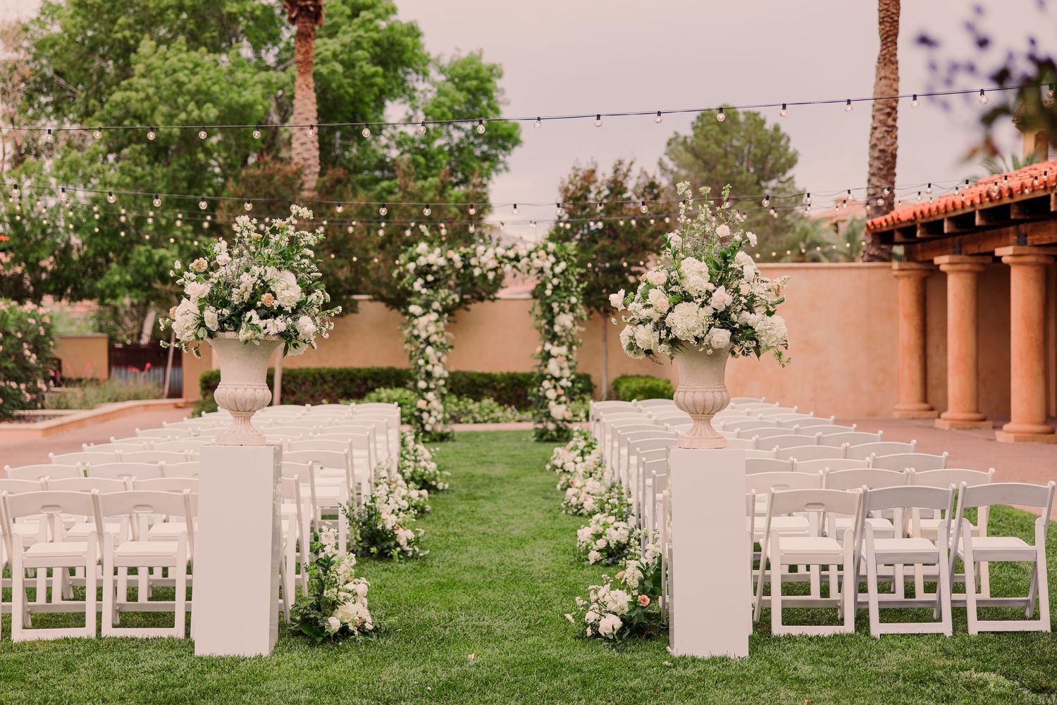 Black and white wedding photos showing a bride in a flowing white dress with a long veil in an elegant hallway setting.