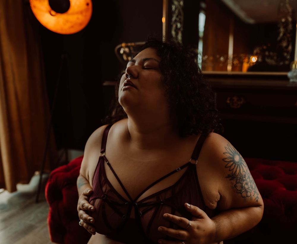 A romantic candlelit dinner scene with intimate lighting creating a cozy ambiance by Boudoir by KJ.
