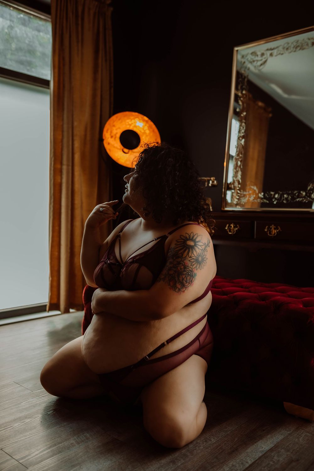 Artistic boudoir photo series showing silhouetted figure against window light in moody indoor setting.