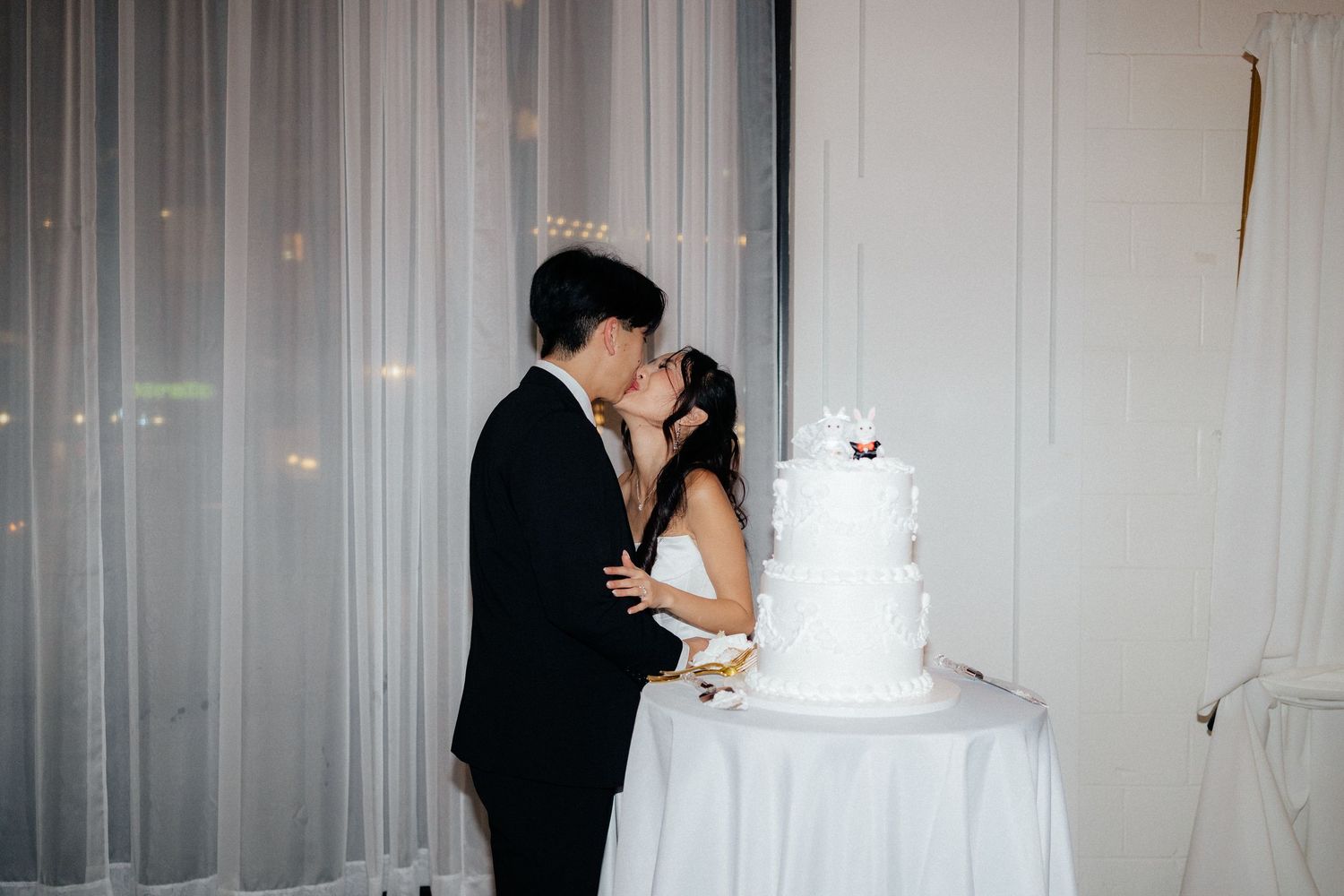 Wedding reception details showing a white tiered cake and elegant decor.