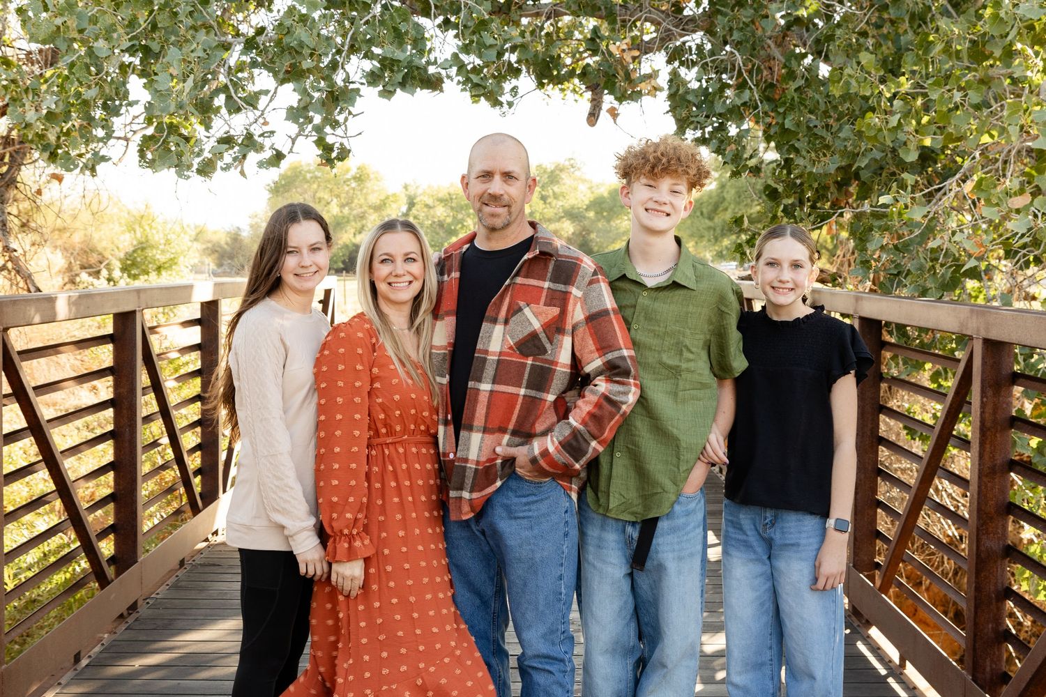 family in southern utah standing on bridge at Kirkland farms