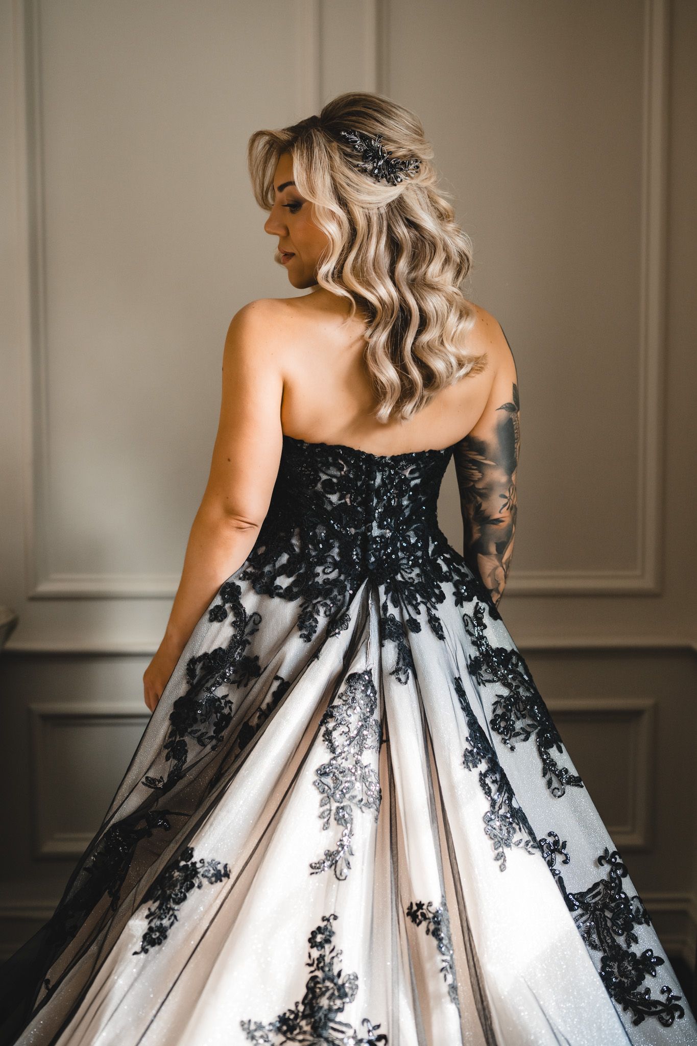 Elegant black and white wedding gown with lace details shown from various back angles.